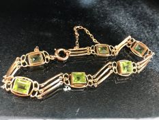 Gold Bracelet marked 15ct with six gold mounted square cut Peridot stones