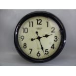 Black metal wall clock marked Camden Clocks London, approx. 47 cm wide