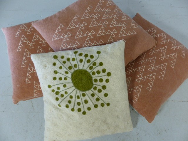 Four modern scatter cushions, three in dusky pink, one in cream/green