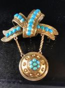 Gold coloured mourning brooch in the form of a twisted ribbon decorated with Turquoise stones and