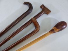 Four hard wood walking canes