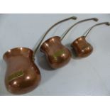 Set of three brass and copper spirit measures/warmers (whisky, Rum, Brandy)