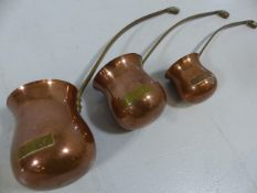 Set of three brass and copper spirit measures/warmers (whisky, Rum, Brandy)