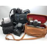 Three vintage cameras to include a Pentax Praktica MTL3, a Minolta Dynax 7000i and a Canon MV890