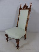 High backed carved single chair with pale green upholstery