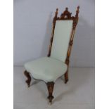 High backed carved single chair with pale green upholstery