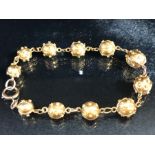 Gold Bracelet of links and graduated studded Gold balls (total weight 13.7g) the clasp marked 9ct,