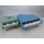 Two vintage baby grand piano toys.