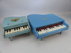 Two vintage baby grand piano toys.
