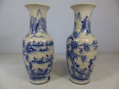 Pair of large oriental blue and white vases depicting mountain scenes. Approx height of each 83cm