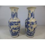Pair of large oriental blue and white vases depicting mountain scenes. Approx height of each 83cm