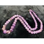 Necklace of faceted and graduated Amethyst stones tightly strunk of approx 74cm in length