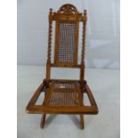 Folding campaign style chair with wicker work and barley twist detail