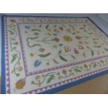 Large contemporary ground rug with floral design on a cream background. Approx. 340cm x 255cm