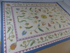 Large contemporary ground rug with floral design on a cream background. Approx. 340cm x 255cm