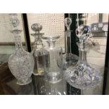 Group of five cut glass decanters with stoppers