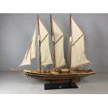 Large wooden scale model of a tall Ship with masts and rigging displayed on a plinth. Length