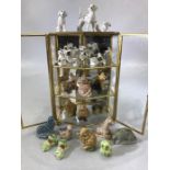 Collection of ceramic animals in a three tier metal display case (height 75cm)