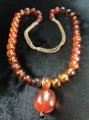 Amber necklace with Gold double strand chain, 37 Amber beads strung and sperated by small clack