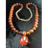 Amber necklace with Gold double strand chain, 37 Amber beads strung and sperated by small clack