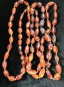 Long string of oval Amber beads knotted and of irregular shapes approx 145cm in total length (A/F)