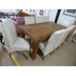 Modern oak extending dining table with eight cream upholstered chairs