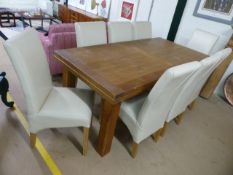 Modern oak extending dining table with eight cream upholstered chairs