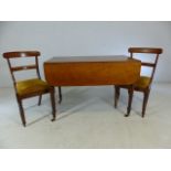 Mahogany pembroke table on castors with two chairs with upholstered seats