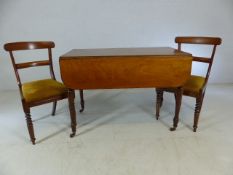 Mahogany pembroke table on castors with two chairs with upholstered seats