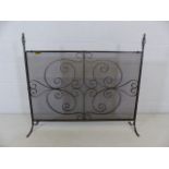 Wrought iron fire guard with decorative design