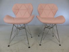 Pair of retro-style pink chairs with chrome legs