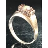 9ct Gold marked 375 ring with central Opal flanked by Diamonds size 'M'