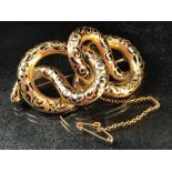 Gold coloured metal double headed snake brooch with 'C' clip and safety chain. tests as high carat