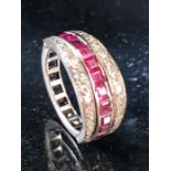 Metamorphic ring with diamond shoulders hinged to flank either a channel of square cut Ruby's or a