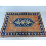 Blue and coral patterned ground rug approx. 182cm x 260cm