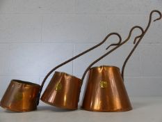 Three graduated copper cider warmers