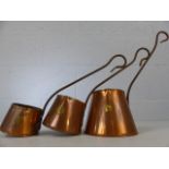 Three graduated copper cider warmers