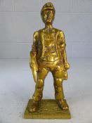 Brass figurine of a miner with a pick axe