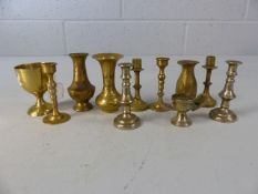 Collection of miniature brass candlesticks and vases