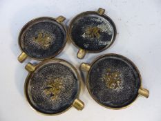 Four matching brass ashtrays with lion passant to centres