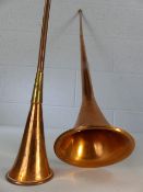 Pair of copper and brass hunting horns, the largest approx. 95cm tall