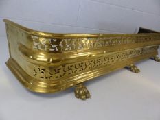 Ornate brass fireside fender on three brass lions paws approx 118cm in length