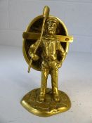 Brass figurine of man carrying a coracle