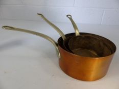 Three graduating copper and brass pans. Diameter of largest approx. 17cm