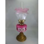 Victorian oil lamp with pink floral design, complete with shade and chimney