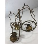 Three hanging brass lamps and a further lamp frame