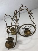 Three hanging brass lamps and a further lamp frame