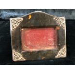 Tortoise shell picture frame with silver mounts depicting hearts and Cherubs (14cm x 12cm) A/F