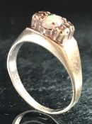 9ct Gold marked 375 ring with central Opal flanked by Diamonds size 'M'