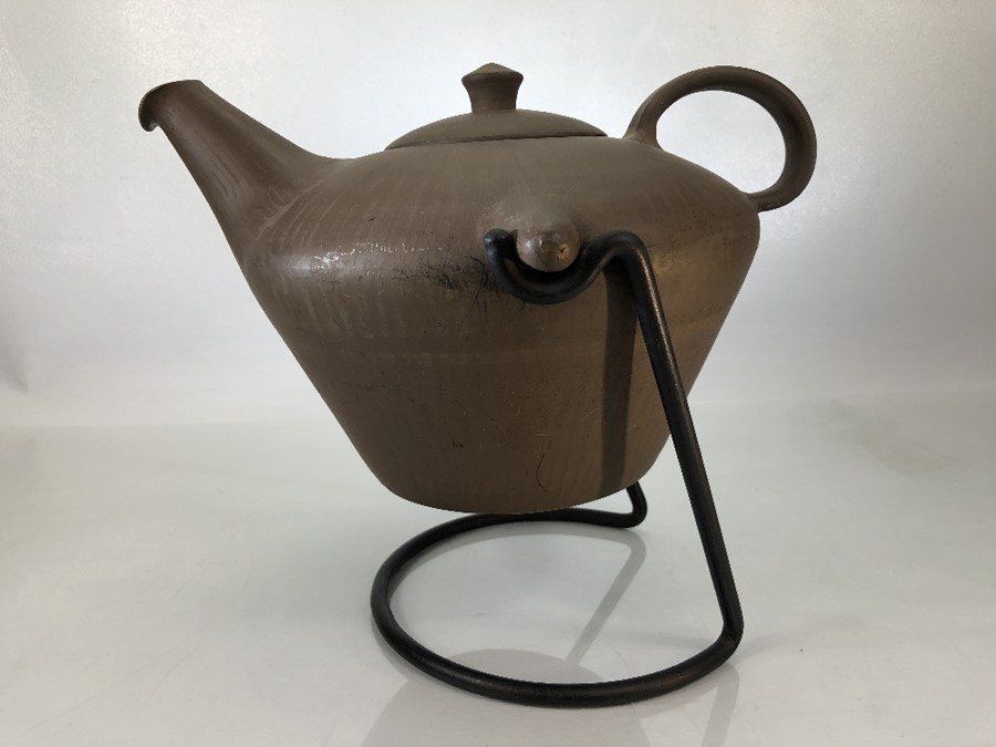 Clay kettle on metal stand